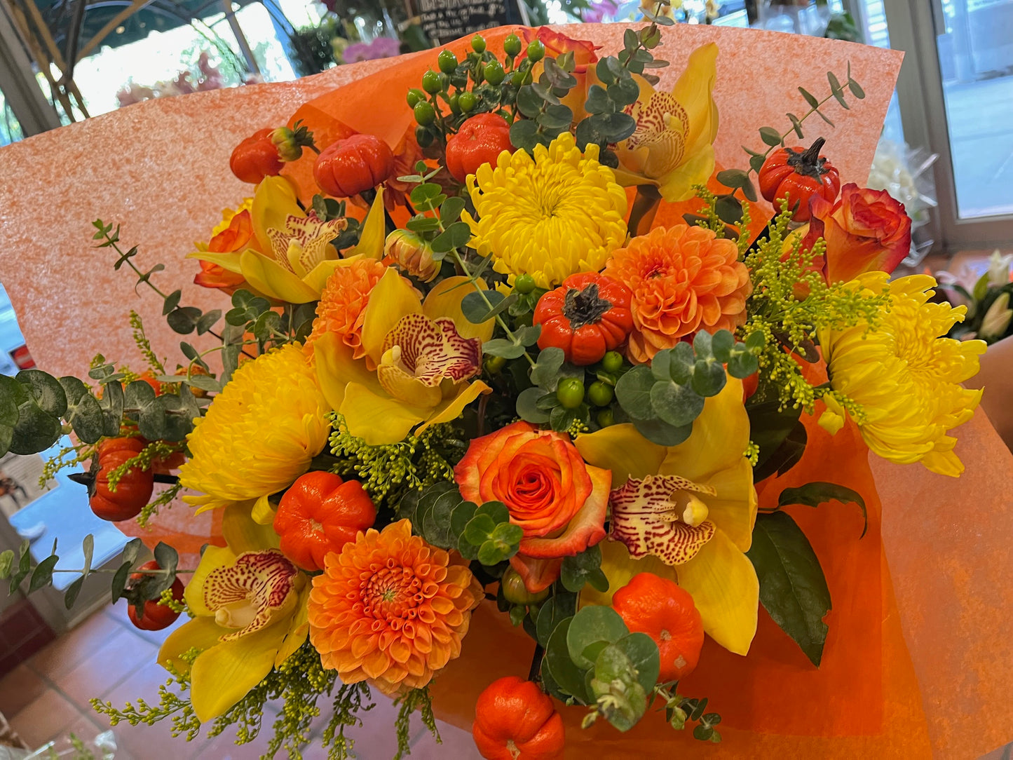 
                    
                      Orange rose, dahlia, cymbidium orchid heads, ruscus and calla lily autumn bouquet – Jerome Florists NYC
                    
                  