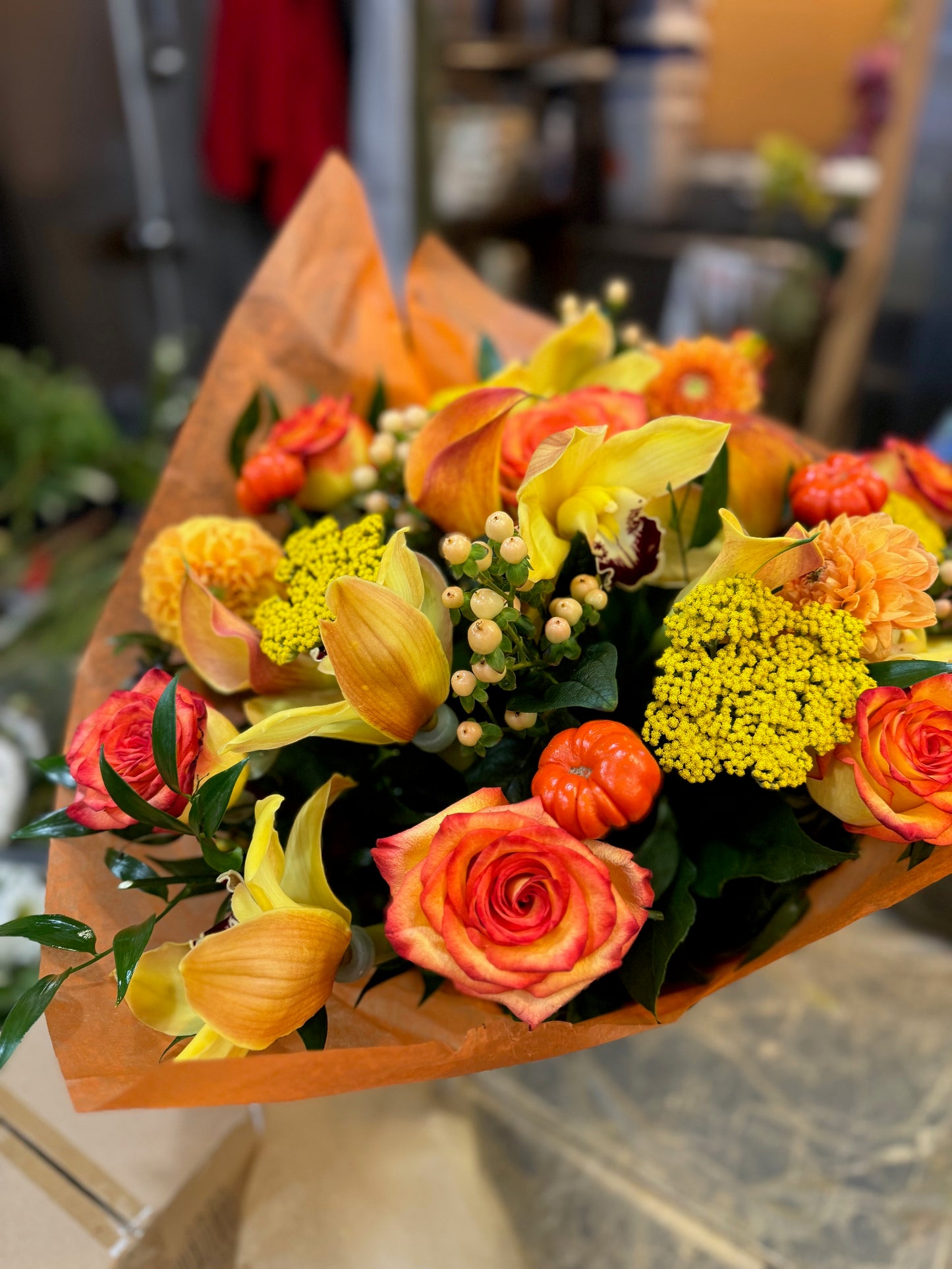 Orange rose, dahlia, cymbidium orchid heads, ruscus and calla lily autumn bouquet – Jerome Florists NYC