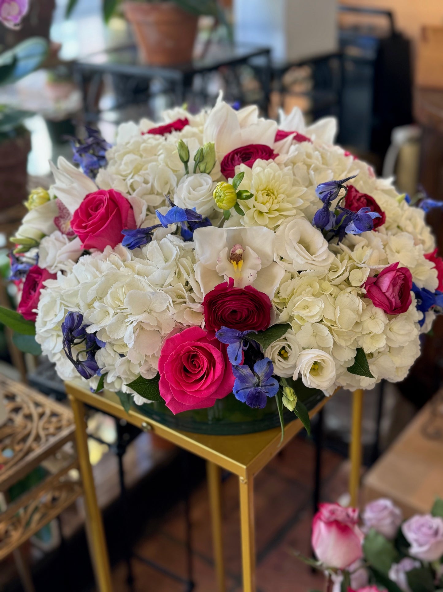 White hydrangea cymbidium orchid rose and ranunculus premium Round centerpiece – Jerome Florists NYC 