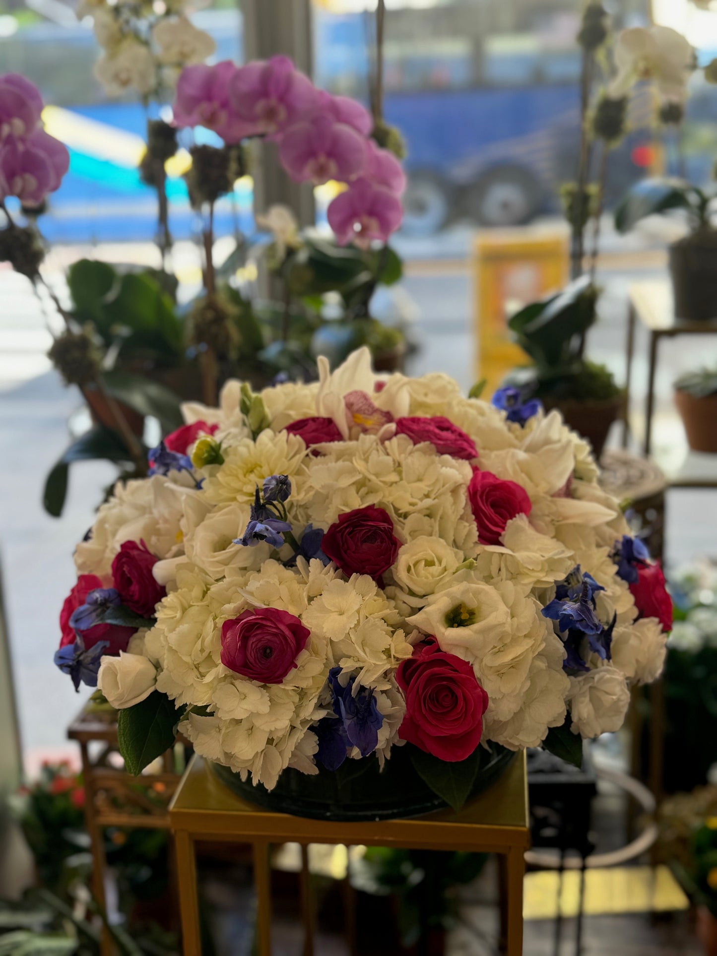 
                    
                      White hydrangea cymbidium orchid rose and ranunculus premium Round centerpiece – Jerome Florists NYC
                    
                  