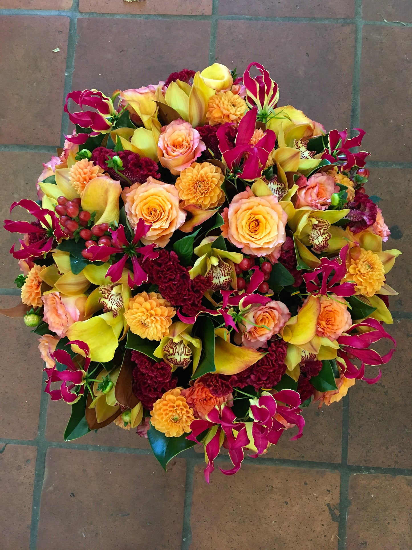 Vivid rose gloriosa lily calla lily and red berry centerpiece – Jerome Florists NYC