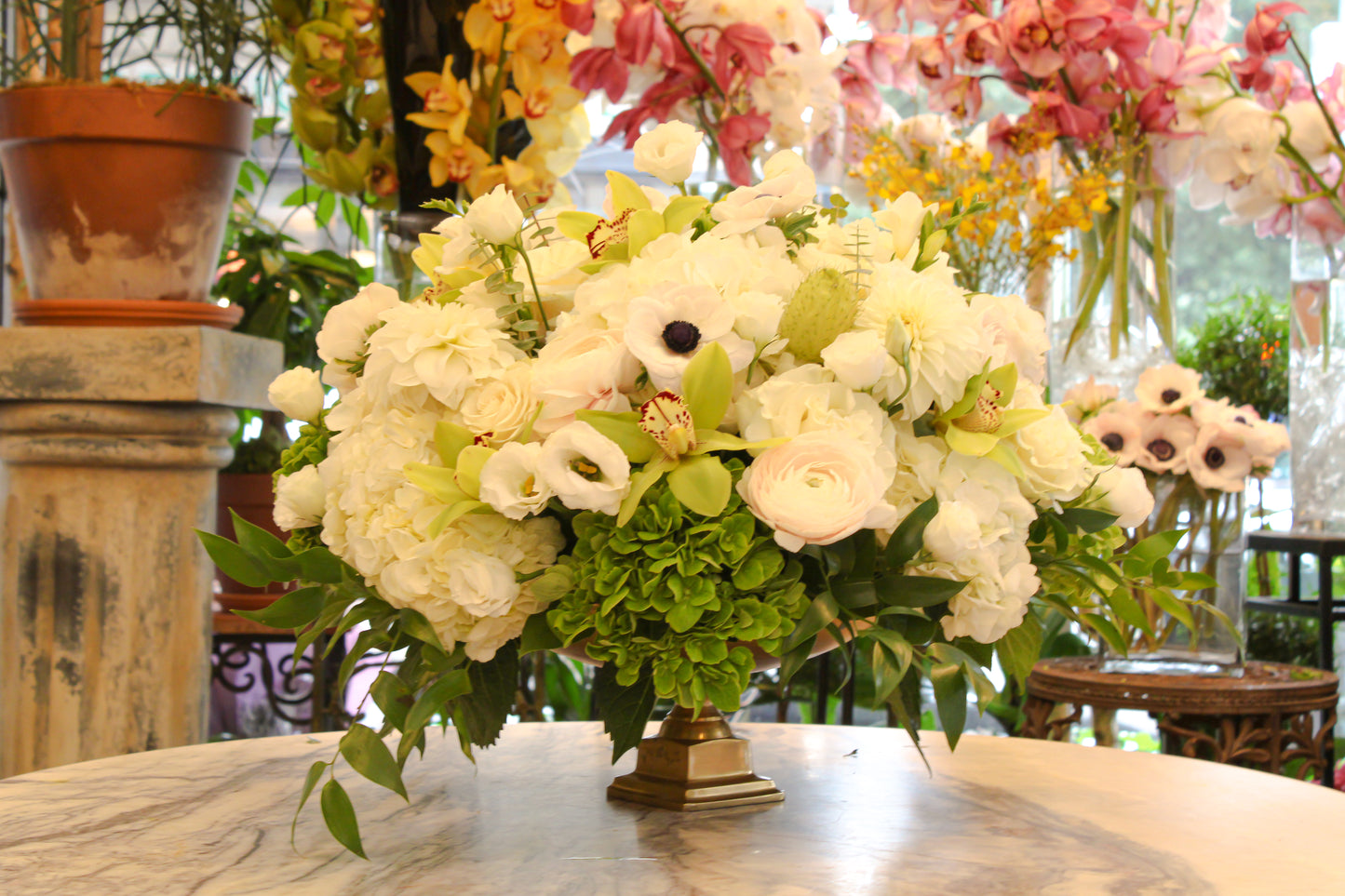 Luxurious white rose, hydrangea, lisianthus, anemones, ranunculus, and orchid arrangement in gold bowl – Jerome Florists NYC