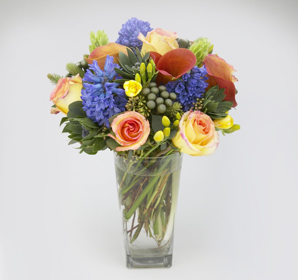 Medley floral arrangement with Ambiance roses, hyacinth, calla lilies, and yellow freesia - Jerome Florists NYC